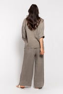 Women's linen loungewear set in taupe, featuring a relaxed-fit button-up top with rolled sleeves and wide-leg pants with a rope belt. Comfortable and breathable outfit for casual wear, travel, or summer days.