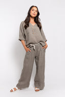 Comfy linen pants set for women in taupe, featuring a loose button-up top with rolled sleeves and wide-leg pants with a stylish rope belt. Perfect for everyday wear, travel, or summer outfits.