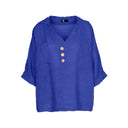 Blue linen blouse for women with a relaxed fit, V-neck, three-button front, and rolled sleeves. Lightweight and breathable, perfect for casual wear, summer outfits, and vacation looks.