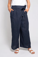 Blue linen wide-leg pants for women featuring a stylish side tie and relaxed fit. Lightweight and breathable, perfect for casual wear, vacations, and summer outfits.