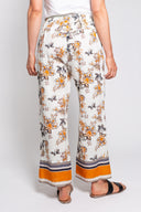 Floral print wide-leg pants for women with an elastic waistband and decorative border hem. Lightweight and breezy, perfect for boho-chic looks, summer outfits, and vacation wear.