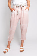 pink tie-dye linen pants for women with a relaxed fit, cropped length, and a decorative belt. Stylish and breathable, perfect for casual wear and boho-inspired outfits.