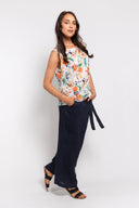 White floral sleeveless top for women with a relaxed fit and vibrant tropical print. Lightweight and breathable, perfect for casual summer outfits and vacations.