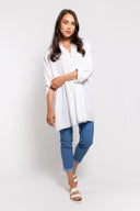 White gauze tunic for women with a button-up front, long sleeves, and a relaxed fit. Lightweight and breathable, perfect for casual wear, layering, and summer outfits.