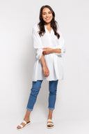 White gauze tunic for women with a button-up front, long sleeves, and a relaxed fit. Lightweight and breathable, perfect for casual wear, layering, and summer outfits.