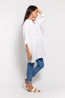 White gauze tunic for women with a button-up front, long sleeves, and a relaxed fit. Lightweight and breathable, perfect for casual wear, layering, and summer outfits.